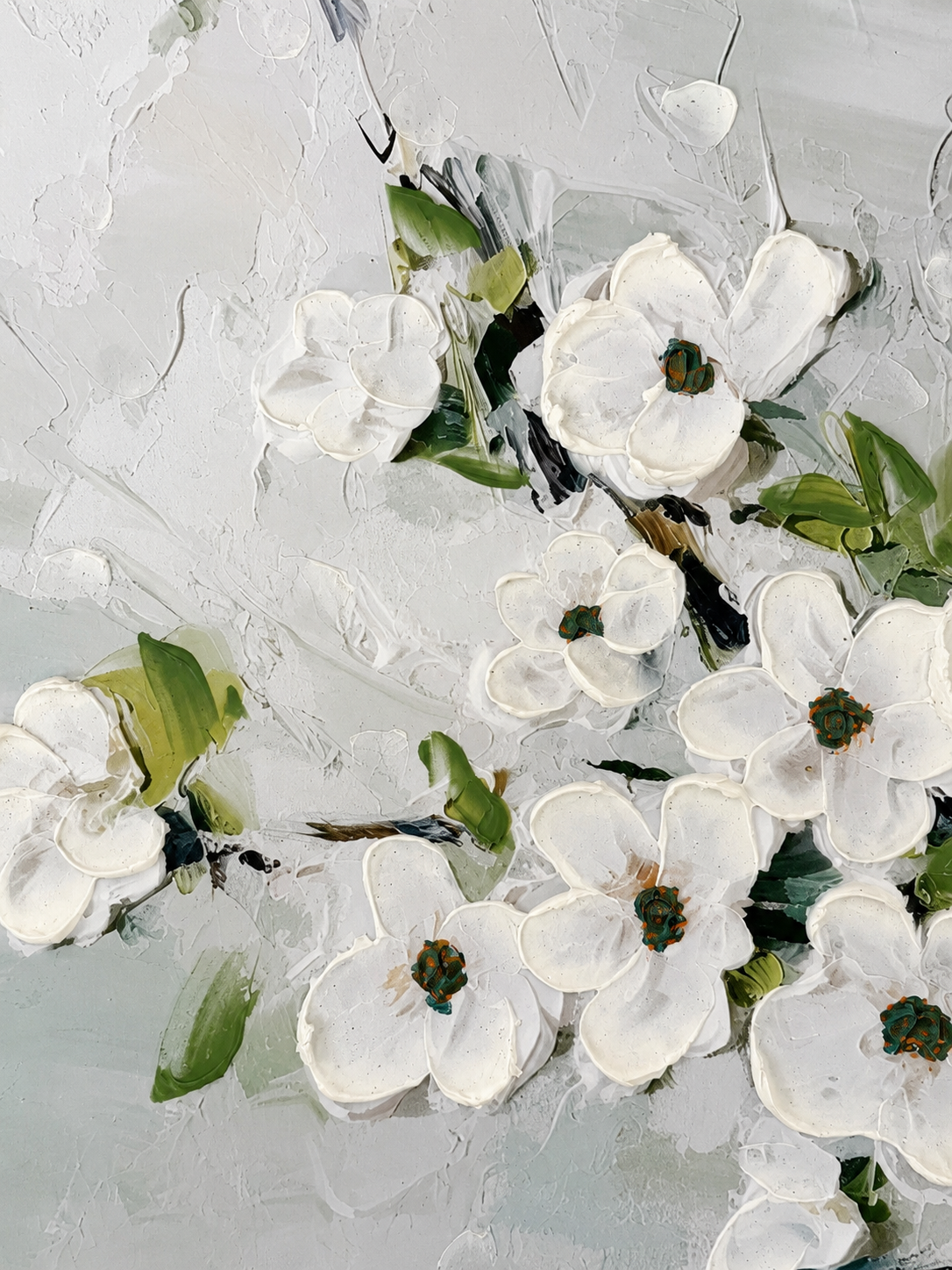 Close-up of white floral artwork displayed inside Resurrection Spa