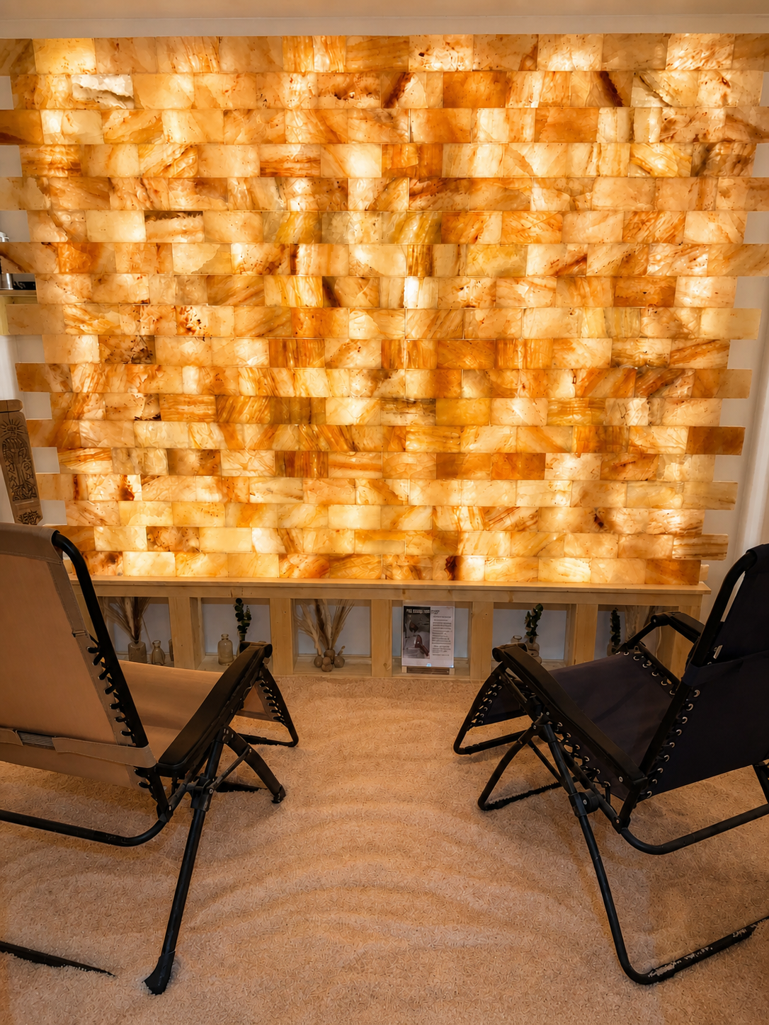 Warmly illuminated Himalayan salt room with reclining chairs
