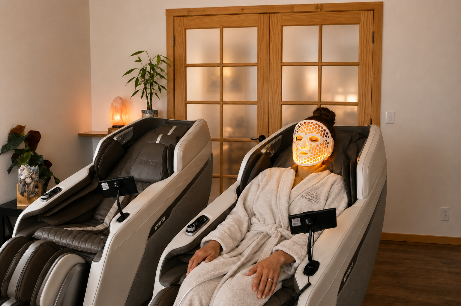 Guest using an LED face mask while relaxing in a massage chair